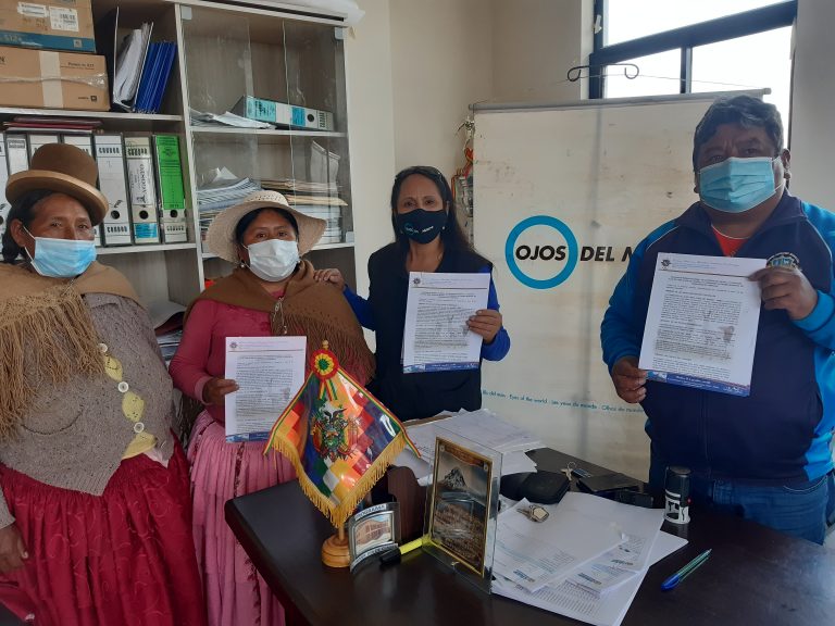 Four people showing the agreement signed