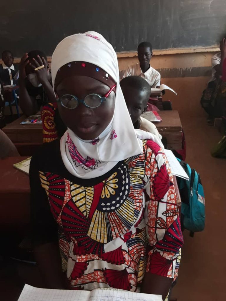 A girl in school with her prescription glasses