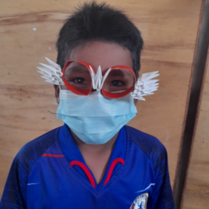 Child wearing glasses made from recycled material in a contest