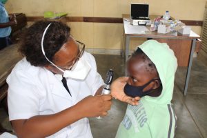 Woman checking a child's vision.