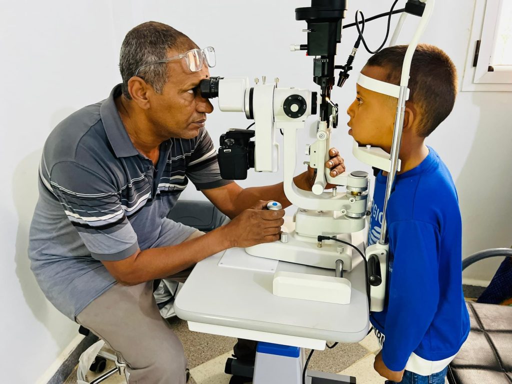 Optometrist performing an eye examination on a Sahrawi child
